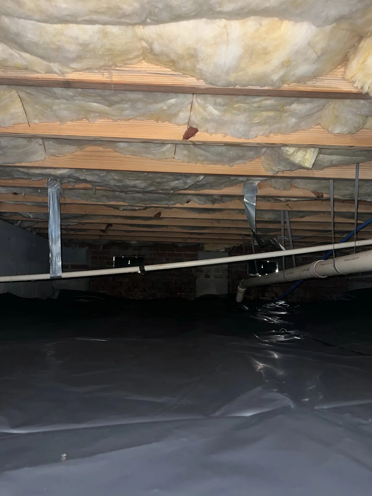 Unfinished crawlspace with exposed dirt floor and no vapor barrier